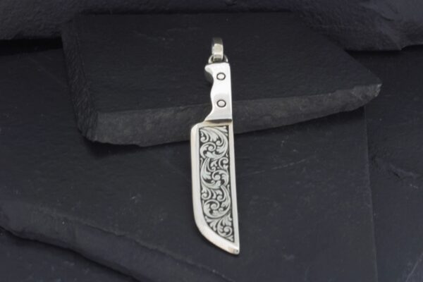 Intricately designed miniature sword pendant with detailed engravings.