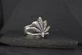 Silver ring shaped like a cannabis leaf.