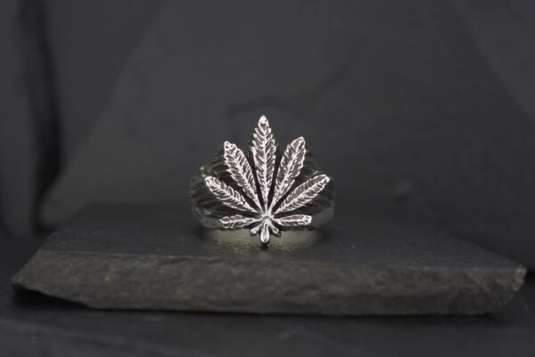 Silver ring shaped like a marijuana leaf.