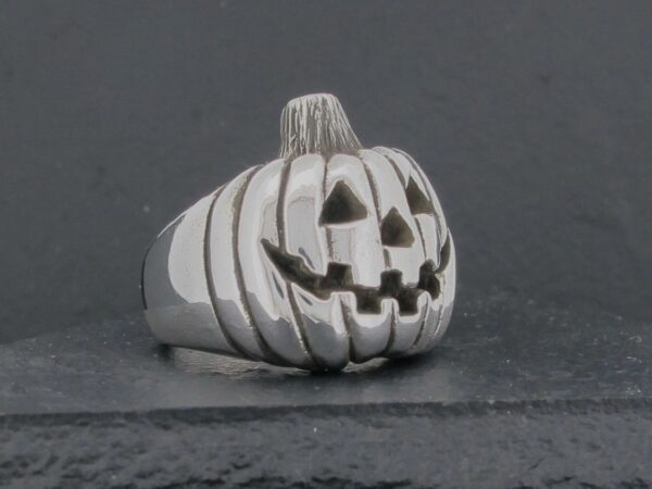 Silver ring shaped like a carved Halloween pumpkin.