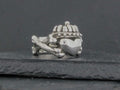 A small, detailed turtle-shaped charm or figurine on a dark surface.