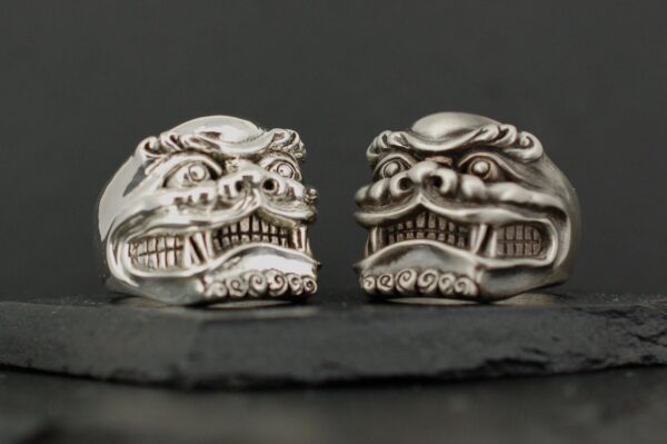 Intricately carved stone lion heads with detailed expressions.