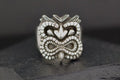 Intricately carved tribal-style ring with a bold design.