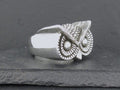 Silver owl-shaped ring with detailed feather design.
