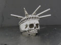 A skull ring designed like the Statue of Liberty's crown.