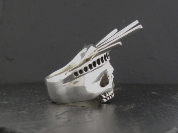 Silver skull ring with multiple spikes.