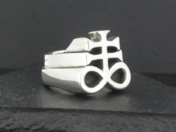 Silver ring with a unique, intricate symbol design.