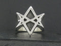 Silver ring featuring a geometric star design.