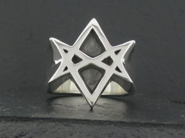 Silver ring featuring a geometric star design.