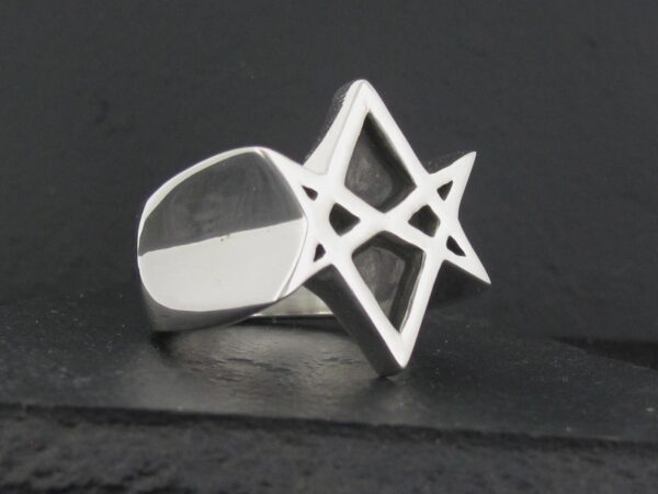 Silver ring featuring a geometric star design.