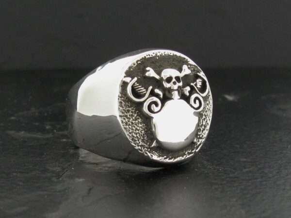 Silver ring with an intricate skull and tentacle design.