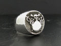 Silver ring with an intricate skull and tentacle design.