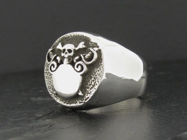 Silver ring with a detailed dragon face design.