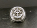 Silver ring with skull and crossed sickles emblem.