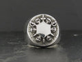Intricately designed silver ring with gothic skull motifs.