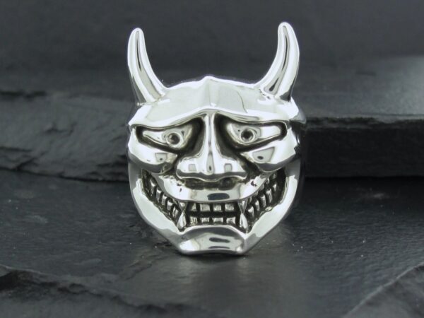 Silver ring shaped like a fierce Oni mask with horns.