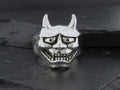 Silver ring shaped like a horned demon face with glasses.