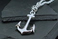 Shiny silver anchor pendant on a textured chain.
