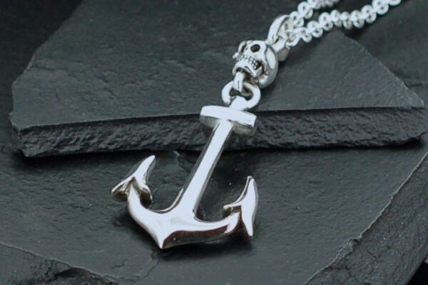 Shiny silver anchor pendant on a textured chain.