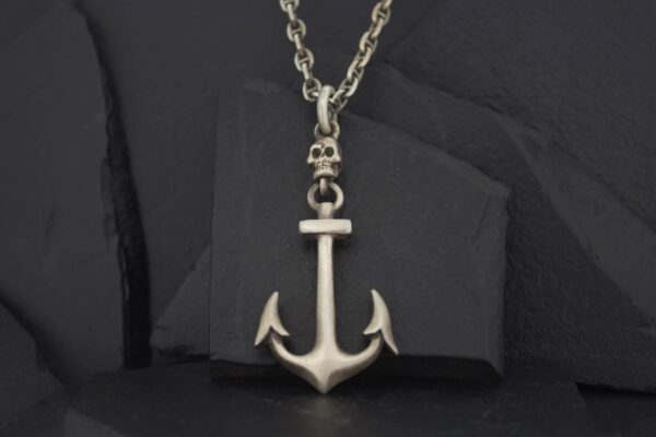 Silver anchor pendant on a chain necklace.