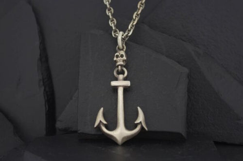 Silver anchor pendant on a chain necklace.