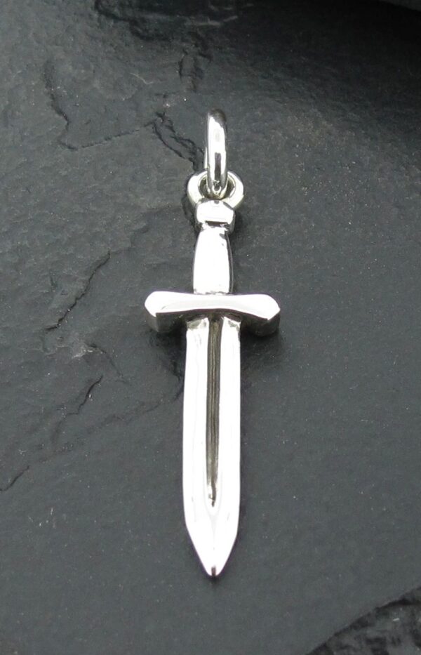 A silver sword pendant on a dark background.