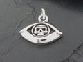 Silver eye-shaped pendant with an astronaut helmet design.