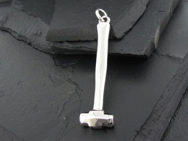 Small silver hammer pendant with a loop for a chain.