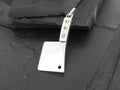 Silver cleaver-shaped pendant with a hole near the blade tip.