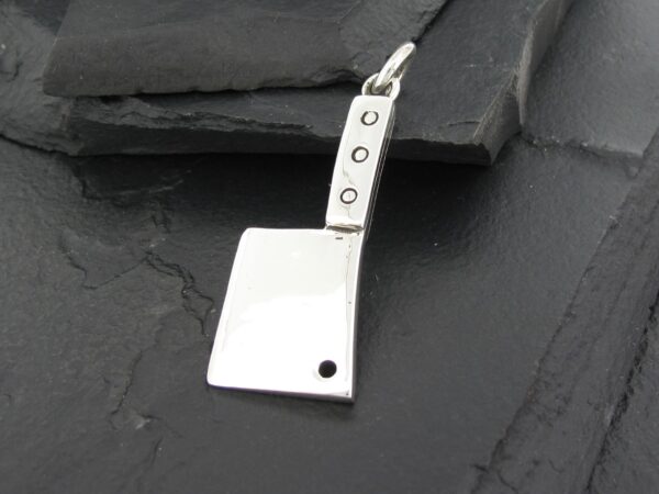 Silver cleaver-shaped pendant with a hole near the blade tip.