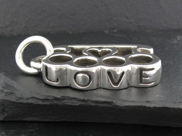 Silver charm with the word 'LOVE' engraved on it.