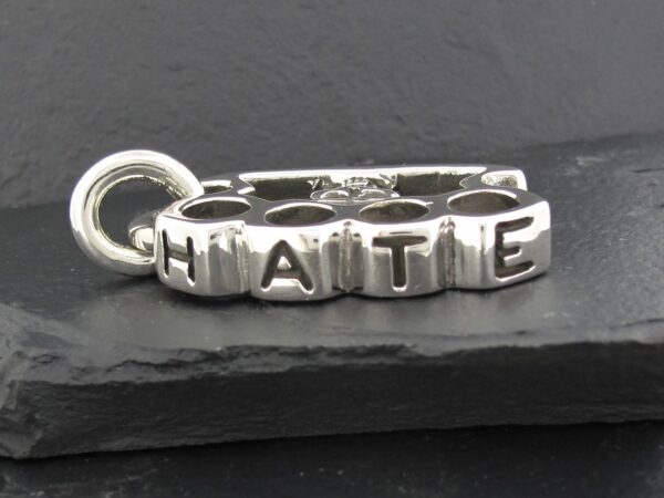 Silver charm with the word 'HAITI' engraved on block letters.