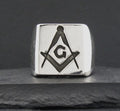 A silver ring with the Masonic square and compass symbol and a 'G' in the center.