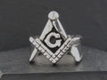 Silver Freemason symbol featuring a compass, square, and letter G.