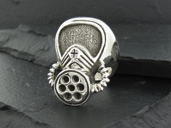 Metal ring with a gas mask design and intricate details.