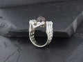 Silver ring with intricate, organic design resembling branches or roots.
