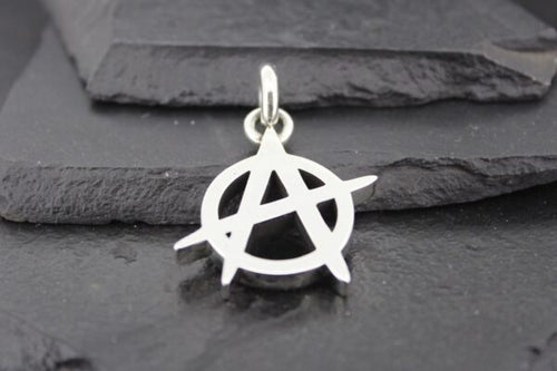 Silver anarchy symbol pendant on a dark textured background.