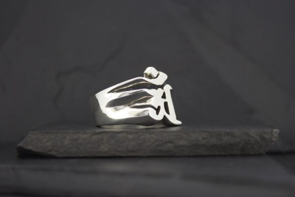 A sleek silver ring with a modern abstract design.