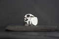 Silver ring with a flame design on a dark surface.