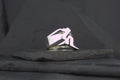 A silver ring featuring a stylized, abstract human figure design.