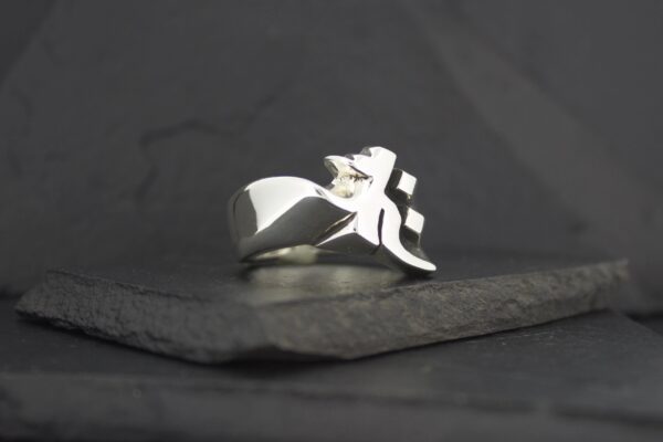 A sleek silver ring featuring a stylized fleur-de-lis design.