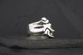 Silver ring featuring a stylized flame design.
