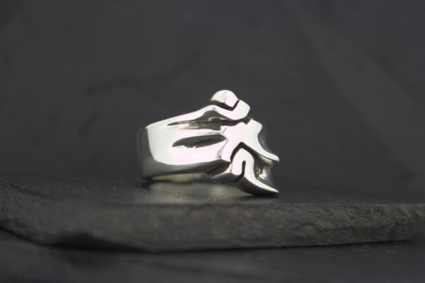 Silver ring featuring a stylized flame design.