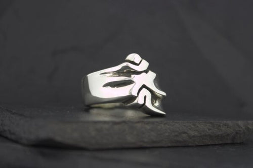 Silver ring featuring a stylized flame design.