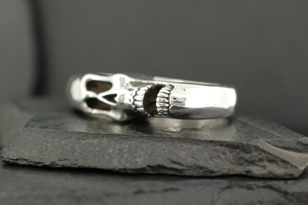 Close-up of a silver ring with intricate detailing.