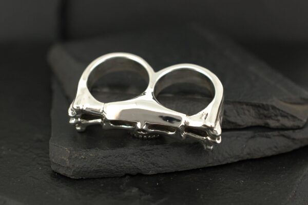 A polished silver double-finger ring with a sleek, modern design.