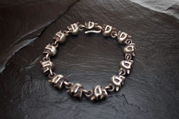 Silver chain bracelet with unique alphabetic beads.