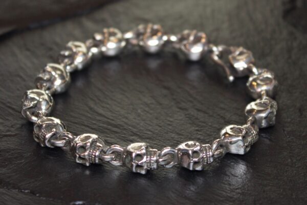 Close-up of a silver skull chain bracelet.