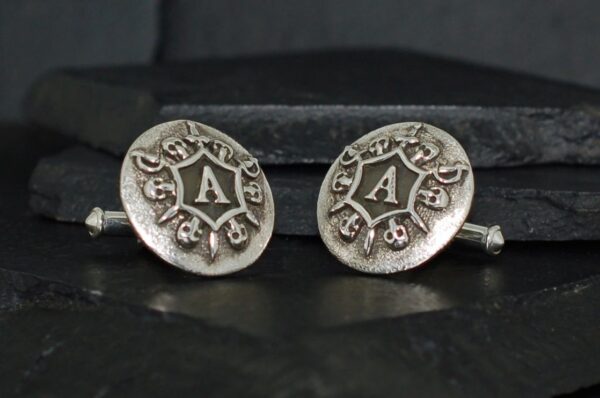 Silver cufflinks with engraved letter 'A' in vintage style.