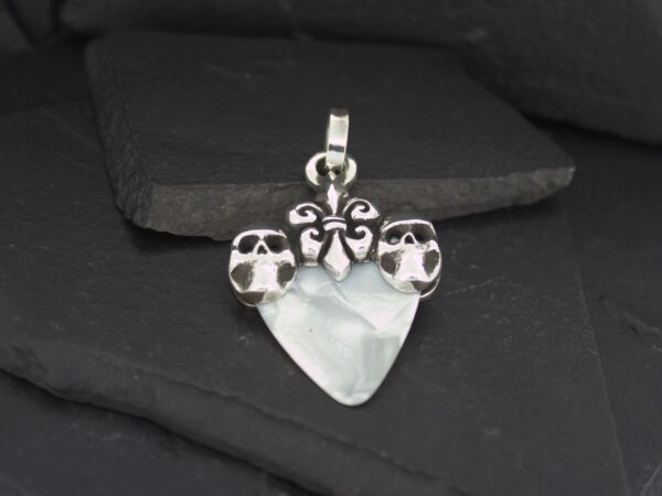 Silver owl pendant with a translucent heart-shaped stone.